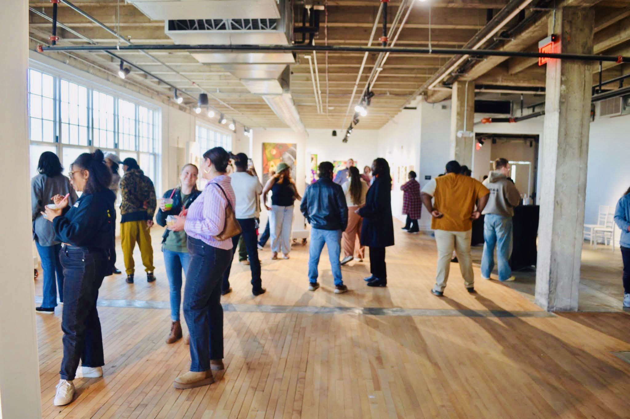 Visitors gathered throughout the Reclaiming the Canvas exhibition
