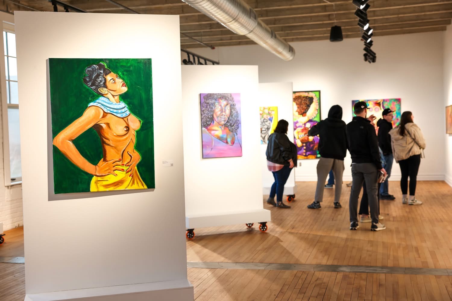 Visitors exploring the Reclaiming the Canvas exhibition