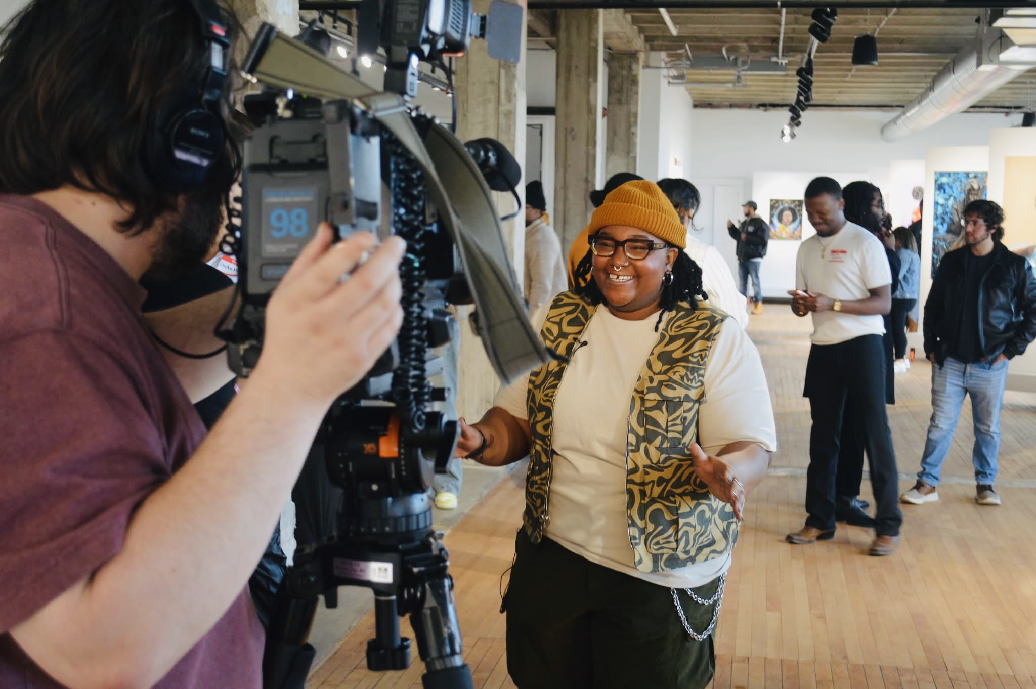 Artist being interviewed on camera during Reclaiming the Canvas