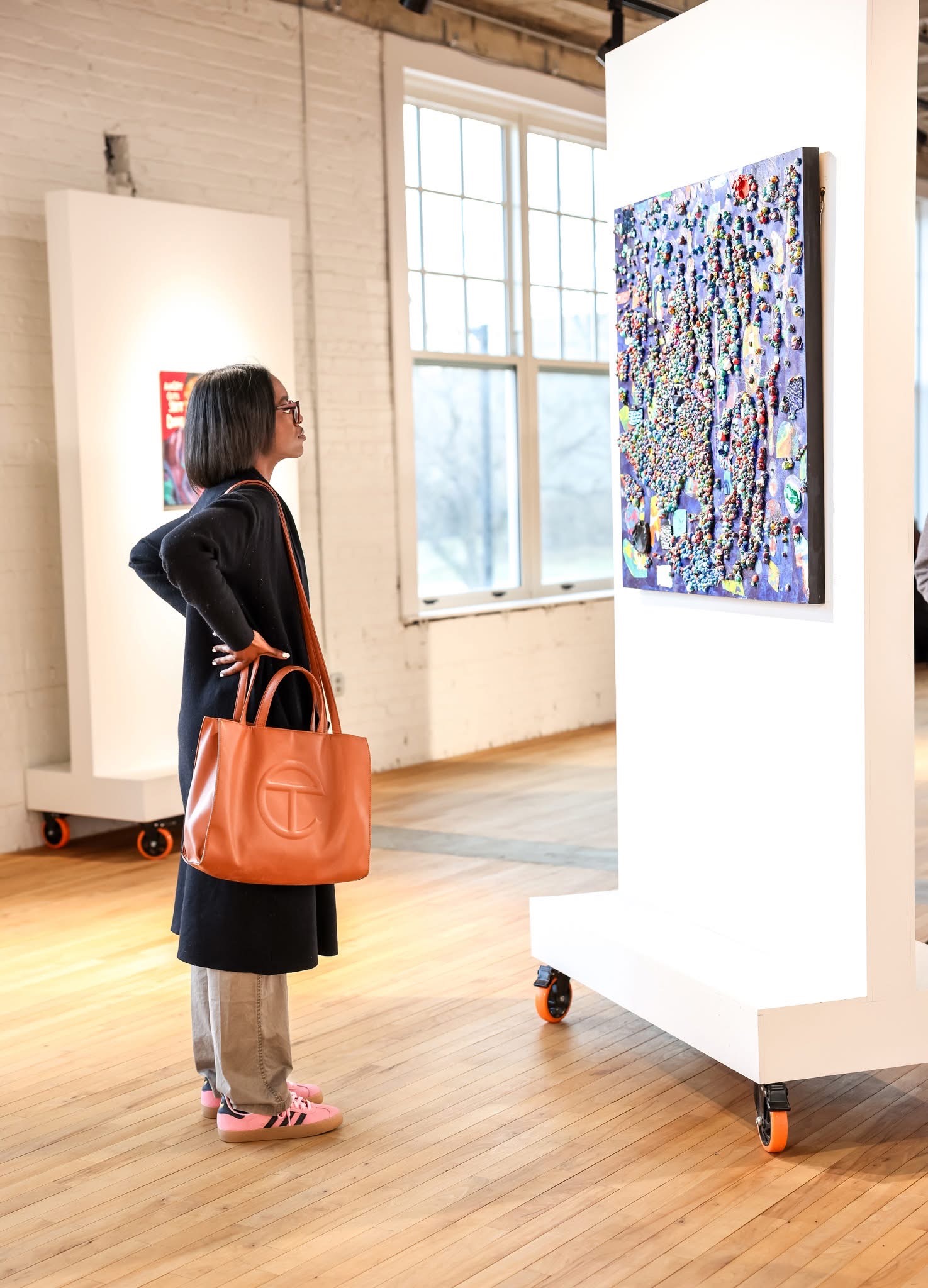 Visitor viewing artwork at Reclaiming the Canvas