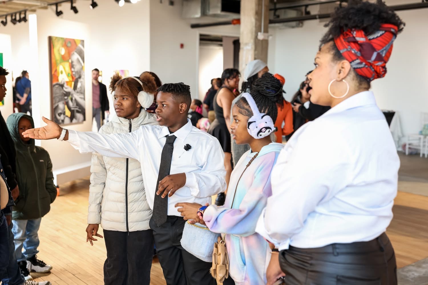 Young attendees discussing artwork during Reclaiming the Canvas